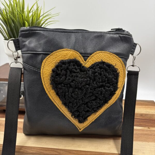 Sac à bandoulière en cuir noir et coeur en mouton de perse